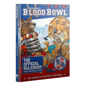 A perspective view of the official hardback book Blood Bowl: The Official Rulebook – Third Season Edition! (Anglais), presented against a clean white background. The top part of the cover features a blue banner displaying the silver tridimensional "WARHAMMER BLOOD BOWL" logo, decorated with red and blue pennants. The central artwork is a vibrant, comic-style illustration depicting a tense face-off in a packed stadium between a human player in red medieval-inspired sports armor with a large stag crest on the left, and a mummified Undead player wearing an imposing golden crown adorned with skulls on the right. The bottom third of the cover has a bright red background featuring a blue block with the white text "THE OFFICIAL RULEBOOK THIRD SEASON EDITION!", flanked by the circular blue "BB" league logo. At the very bottom, the white inscription "THE GAME OF FANTASY FOOTBALL" is framed by two white stars. The spine of the book is visible on the left side, mirroring the blue theme and official typography.