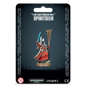 Emballage sous blister officiel d'une figurine de personnage pour le jeu de stratégie Warhammer 40,000, présenté de face avec une fente d'accroche au sommet. Le fond du carton est d'un noir mat texturé, s'estompant vers un rectangle bleu-gris sombre au centre où est représentée la figurine. En haut au centre, une inscription blanche stylisée affiche "CRAFTWORLDS SPIRITSEER". Au cœur de l'emballage se trouve le Spirite (indiqué Spiritseer en anglais), un sorcier mystique de la faction Aeldari entièrement assemblé et peint. Il porte de longues robes rouges fluides aux bordures blanches et dorées, un casque conique blanc doté d'une visière lisse d'un noir de jais, et se tient debout sur un petit socle texturé d'herbe. Le personnage brandit une épée énergétique incurvée de couleur turquoise d'une main et tient un long bâton runique doré orné de gemmes multicolores et d'une icône triangulaire complexe de l'autre. La bordure inférieure noire présente le logo officiel de Warhammer 40,000 en vert et argent, le logo Citadel blanc, le marquage CE, ainsi qu'un pictogramme d'avertissement de sécurité pour les enfants de moins de 3 ans. Des lignes de texte d'avertissement en plusieurs langues encadrent verticalement les côtés gauche et droit.