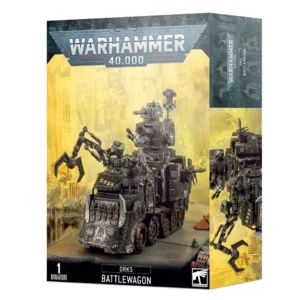 Boîte d'emballage officielle de Warhammer 40,000 au format vertical, présentant une figurine de véhicule pour l'armée des Orks. L'illustration principale, sur un fond jaune brumeux de cité industrielle dévastée, met en scène une immense forteresse mobile en métal noir connue sous le nom de Chariot d'Guerre. Ce véhicule d'assaut asymétrique possède de grandes roues à l'avant et des chenilles à l'arrière. Il est équipé à l'avant d'un gigantesque éperon blindé orné de pointes métalliques évoquant des dents acérées, d'un long bras mécanique articulé muni d'une pince, et d'une imposante tourelle supérieure armée d'un canon lourd. Plusieurs artilleurs Orks à la peau verte manœuvrent les armes de bord. Le logo officiel argenté "WARHAMMER 40,000" domine le haut de la boîte. La bande noire inférieure affiche les mentions textuelles "1 MINIATURE", "ORKS BATTLEWAGON" au centre, ainsi que le logo de Games Workshop dans le coin inférieur droit.