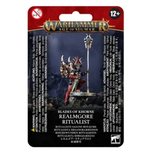 Visuel de l'emballage sous blister de la figurine du Ritualiste Saigne-royaume pour la faction Blades of Khorne dans Warhammer Age of Sigmar. La carte de conditionnement présente en haut une bannière rouge bordeaux avec le logo officiel Warhammer Age of Sigmar en lettres métalliques dorées. Au centre, la figurine peinte met en scène un prêtre menaçant arborant un masque de crâne surmonté d'une coiffe à piques rouges et noires. Vêtu d'une armure rouge sombre avec des crânes suspendus à ses épaulettes, le personnage tient une dague rituelle et s'appuie sur un grand bâton de pouvoir surmonté d'un crâne cornu et de l'icône de Khorne. Le bas de l'emballage indique BLADES OF KHORNE REALMGORE RITUALIST suivi du nom traduit RITUALISTE SAIGNE-ROYAUME en lettres blanches, avec le logo carré blanc Citadel Warhammer dans le coin inférieur droit.